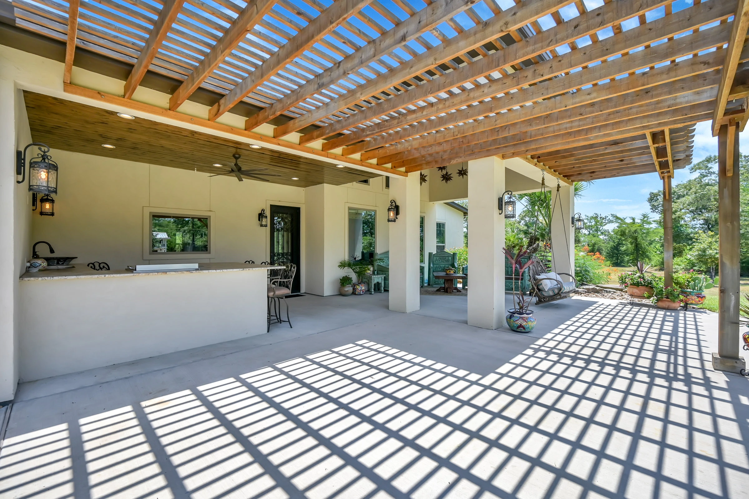 Huntsville Home Builder for Hacienda Spanish Style back patio showing kitchen and sitting area