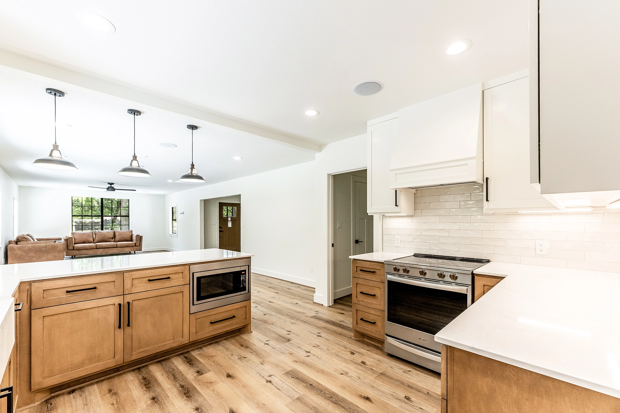 Home Remodel with kitchen leading living area and front door